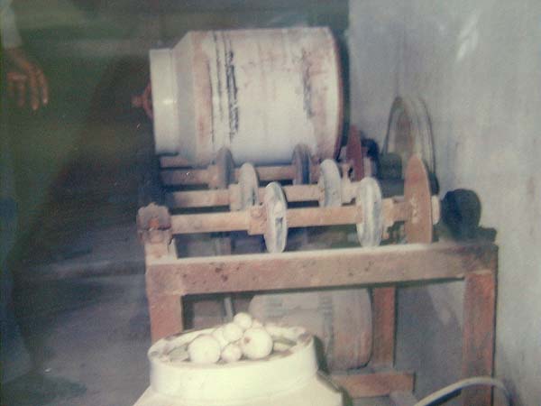 2.球浆机：将原矿研磨好的砂装入球筒中(如图白色圆筒状者即是)，再放入大小不一的圆瓷球及清水后塞盖，置放于球浆机上滚碾数天，再开盖将泥浆水倒入乾净的水缸中沉淀数日，即可取出球浆使用。